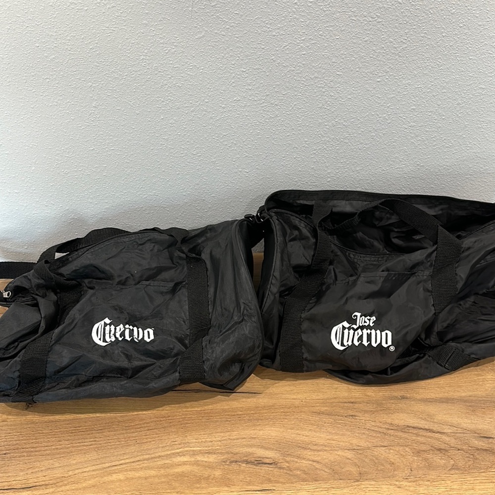 Two Jose Cuervo duffel bags barrel bags black white